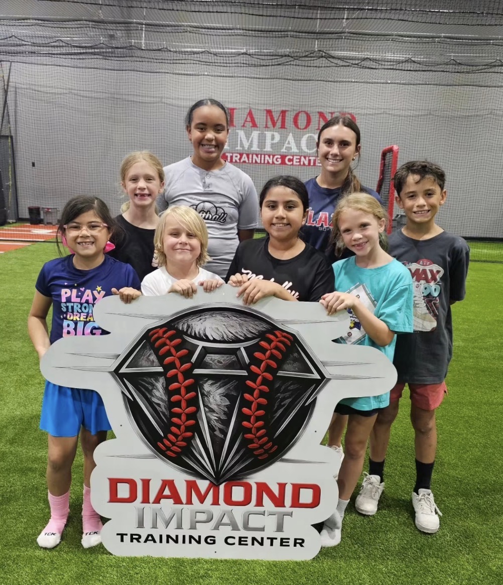 Kaylee Covanes with a group of young players at Diamond Impact Training Center
